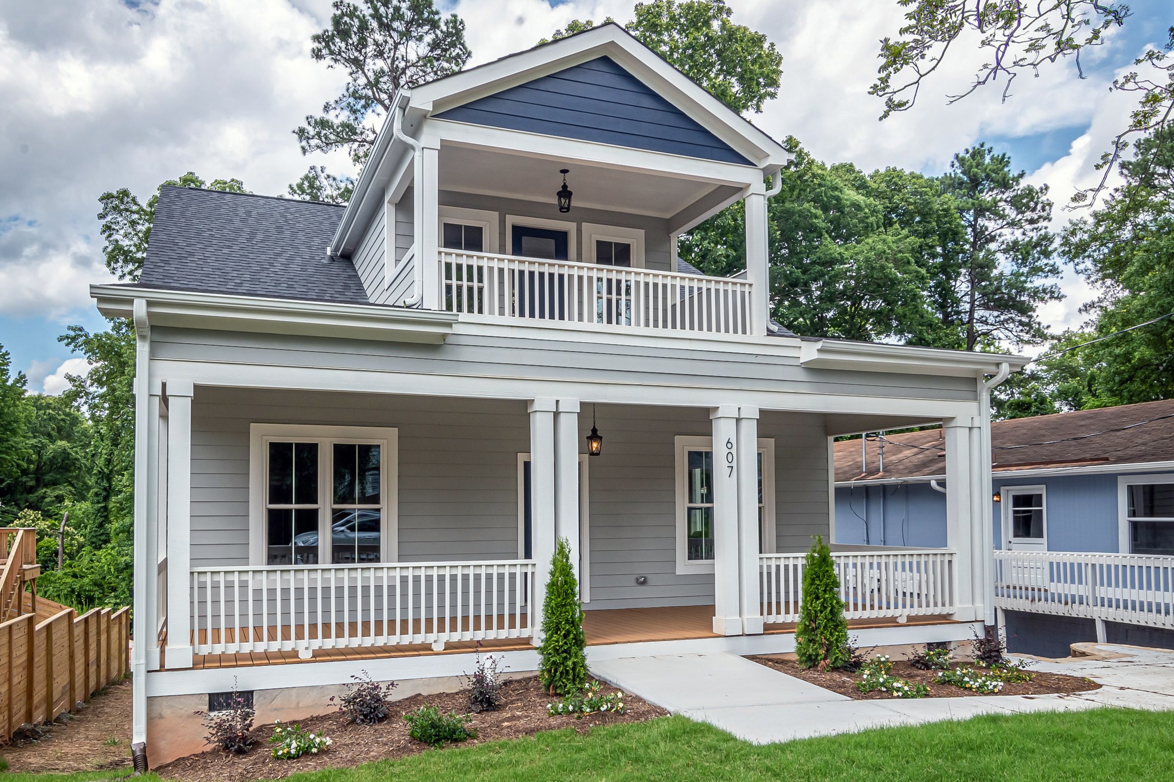 Two-story white home with a covered front porch and balcony